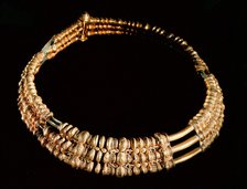Three-ringed collar with filigree granulation and carved figures.