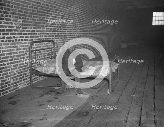 Negro flood refugee in the Red Cross temporary infirmary of Forrest City, Arkansas, 1937. Creator: Walker Evans.