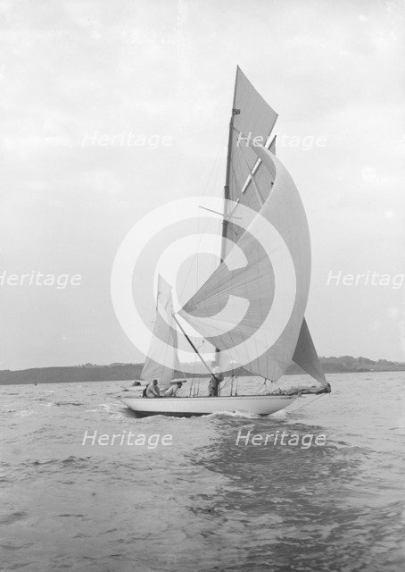 The 8-metre 'Ierne' sailing with spinnaker, 1913. Creator: Kirk & Sons of Cowes.
