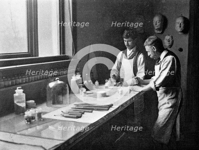 In Professor Herkomer's enamelling studio, grinding colours, 1899. Artist: Unknown