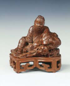Bamboo carving of a scholar leaning against a rock, China, c1662-c1722. Artist: Unknown