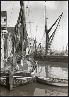Sailed fishing vessels moored beside timber warehouses at Rochester, Medway, 1925-1935. Creator: J Dixon Scott.