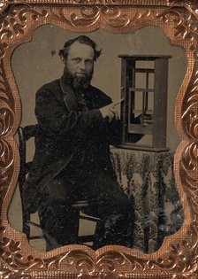 Seated Man Demonstrating Vertical Sliding Window Model, late 1850s-60s. Creator: Unknown.