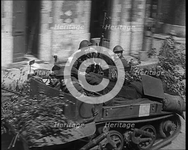 British Expeditionary Force Retreating Through Belgian Town on Vehicles, 1940. Creator: British Pathe Ltd.