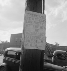 Sign tacked to pole near the post office, Main street, Pittsboro, North Carolina, 1939. Creator: Dorothea Lange.