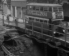 A Bus Driving Across a Wooden Bridge, 1940. Creator: British Pathe Ltd.