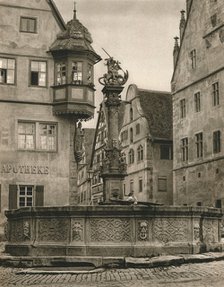 'Rothenburg o. d. T. - St. George's Fountain - Marien-Apotheke', 1931. Artist: Kurt Hielscher.