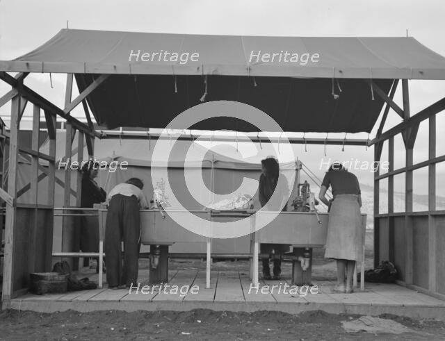 Portable laundry unit, shower unit beyond, FSA camp, Merrill, Oregon, 1939. Creator: Dorothea Lange.