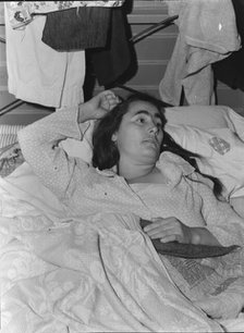Sick woman in FSA camp for migratory agricultural workers, Tulare County, California, 1939. Creator: Dorothea Lange.
