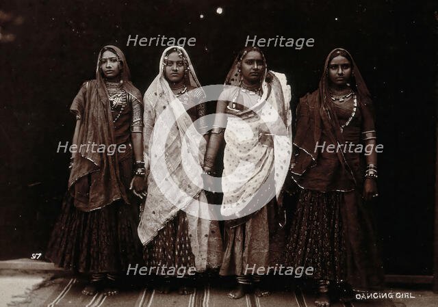 A troupe of nautch dancing girls, standing in a line holding hands, in a studio setting, c1900. Creator: Unknown.