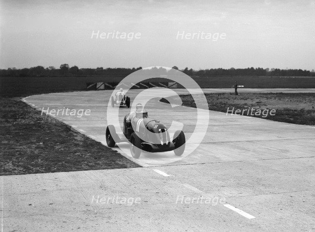 Rapier Special Racing single seater leading a MG in a race on the Campbell Circuit at Brooklands. Artist: Bill Brunell.