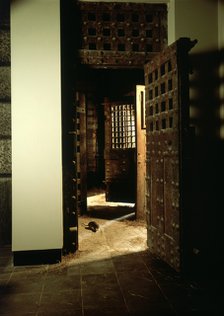 A reconstruction of a corridor in Newgate Gaol, with original doors. Artist: Unknown