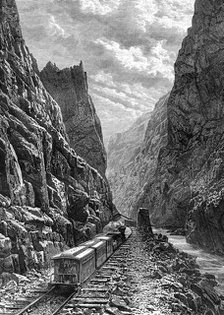 A train passing through the Rocky Mountains, USA, 19th century.Artist: Taylor