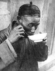 A man eating, Mukden (Shenyang), China, 1936.Artist: Wide World Photos