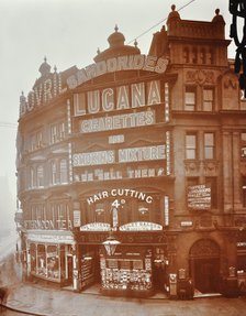 Illuminated advertisements on shop fronts at 7, Oxford Street, London, 1909. Artist: Unknown.