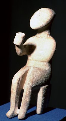 Cycladic marble seated figure holding a cup. Artist: Unknown