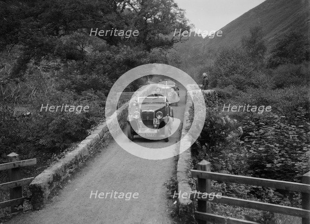 MG M type crossing Figle Bridge during a motoring trial, Devon, c1930s. Artist: Bill Brunell.