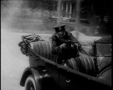 Male American Police Officers on a Car Shooting a Gunmachine on Persue, 1930. Creator: British Pathe Ltd.