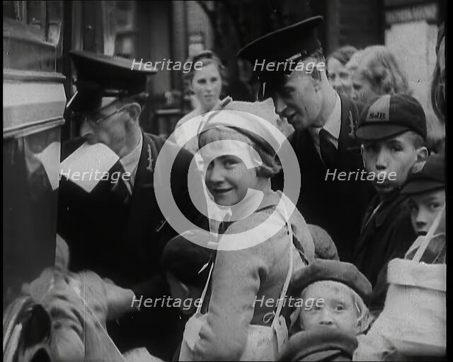 British Male and Female Evacuees Waiting to Board a Bus With Two Male Bus Staff Standing..., 1939. Creator: British Pathe Ltd.