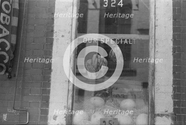 A shop window, 61st Street between 1st and 3rd Avenues, New York, 1938. Creator: Walker Evans.