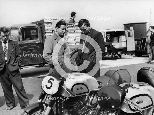 John Surtees with Nortons in paddock at 1954 Isle of Man T.T.. Creator: Unknown.