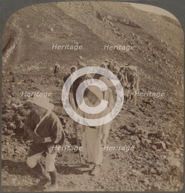 'Pilgrims, at end of weary ascent, in worship encircling crater of sacred Fujiyama, Japan', 1904. Artist: Unknown.