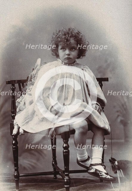 Nora Schuster aged 3, seated, facing forwards, c1895. Creator: Mrs Fred Wilkinson.