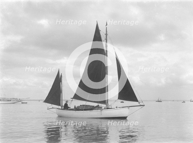 The 4 ton yawl 'Mandy' under sail, 1922. Creator: Kirk & Sons of Cowes.