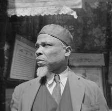 A follower of the late Marcus Garvey who started the "Back to Africa" movement, New York, 1943. Creator: Gordon Parks.