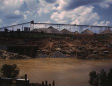 Above the construction work, the aggregate storage pile which..., Fort Loudoun Dam, Tenn., 1942. Creator: Alfred T Palmer.
