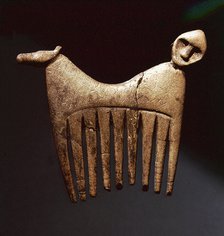 Comb decorated with a human and animal head.