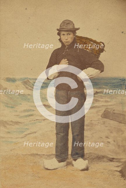 Dutch boy in front of painted sea background, 1865-1875. Creator: Willem Frederik Vinkenbos.