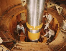 Checking the alignment of a turbine shaft at the top of the guide..., Watts Bar Dam, Tenn., 1942. Creator: Alfred T Palmer.