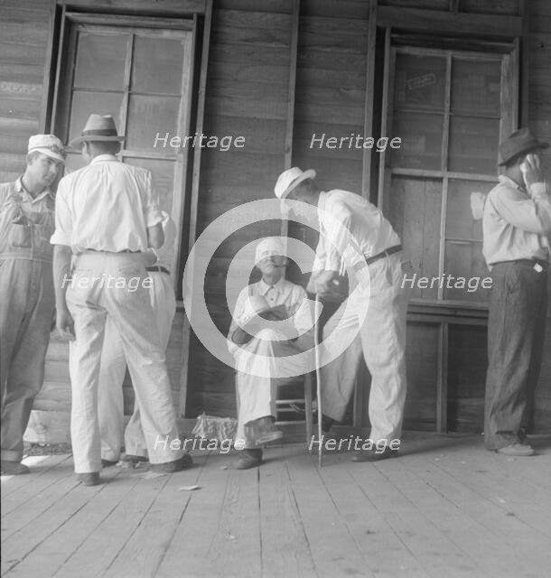 Farmers at tobacco auction, Douglas, Georgia, 1938. Creator: Dorothea Lange.