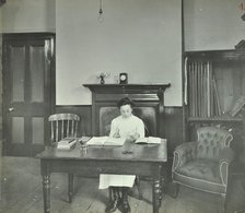 Female student sitting at desk, Shoreditch Technical Institute, London, 1907. Artist: Unknown.