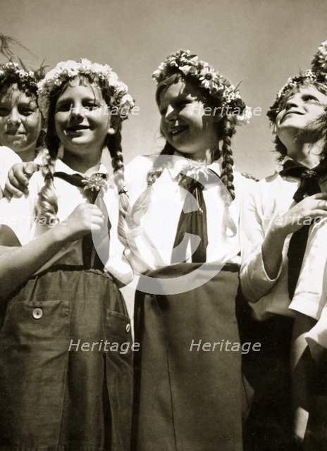 Four German girls smiling with garlands in their hair, c1936. Artist: Unknown