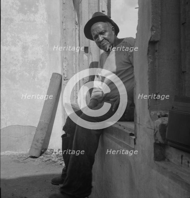 The one inhabitant remaining in Fullerton, Louisiana, an abandoned lumber town, 1937. Creator: Dorothea Lange.