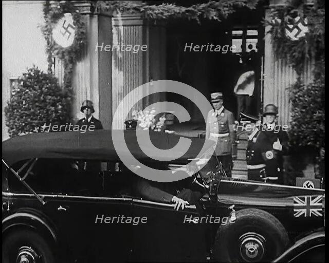 Adolf Hitler, the German Leader Coming Out of a Building in Bad Godesburg With Male German..., 1938. Creator: British Pathe Ltd.