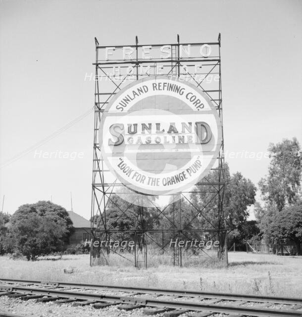 Illuminated sign, approaching San Joaquin Valley town, outskirts of Fresno, on U.S. 99, CA, 1939. Creator: Dorothea Lange.