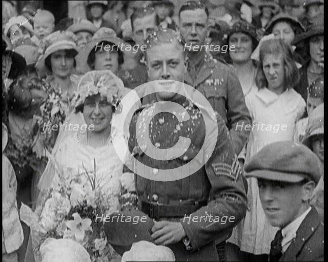 British Bride and Groom Smiling for the Camera at Their Wedding, 1921. Creator: British Pathe Ltd.