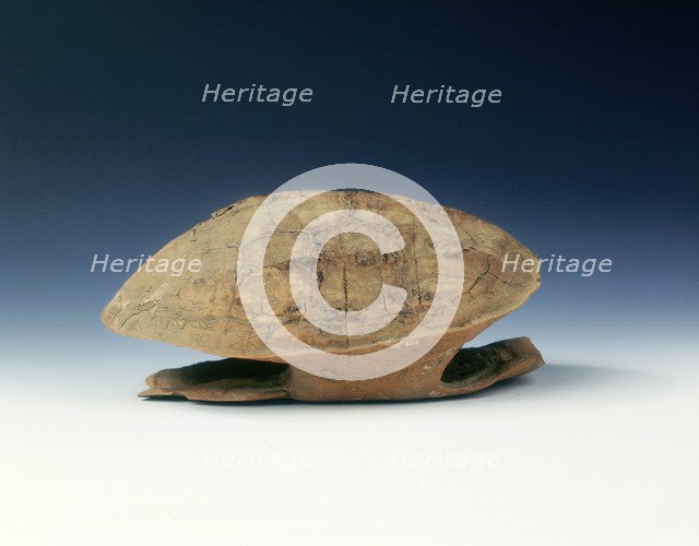 Petrified tortoise shell with oracle bone inscriptions, possibly Shang Dynasty, China, c1400 BC. Artist: Unknown