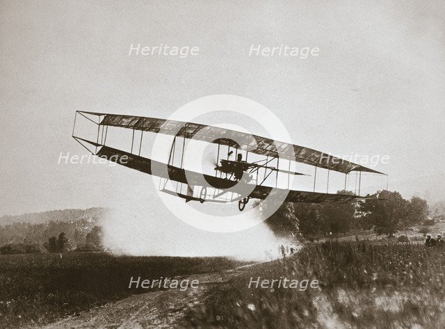 American aviator Glenn Curtiss making the first heavier-than-air flight in his 'June Bug', 1908. Artist: Edwin Levick