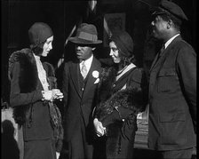 Smartly Dressed People in Conversation On the Streets of New York City, 1932. Creator: British Pathe Ltd.