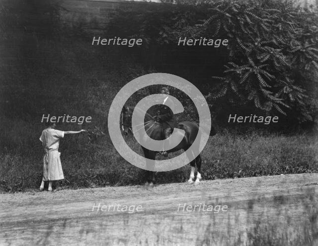 Arnold Genthe riding Chesty, between 1911 and 1936. Creator: Arnold Genthe.