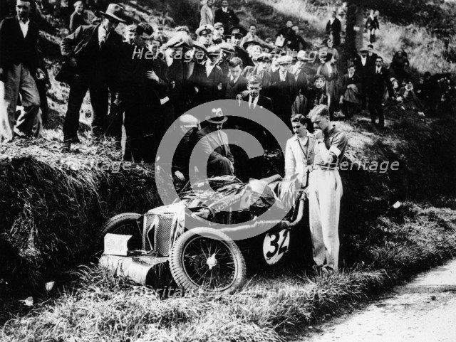Goldie Gardner by the wreckage of an MG J4, 1932. Artist: Unknown