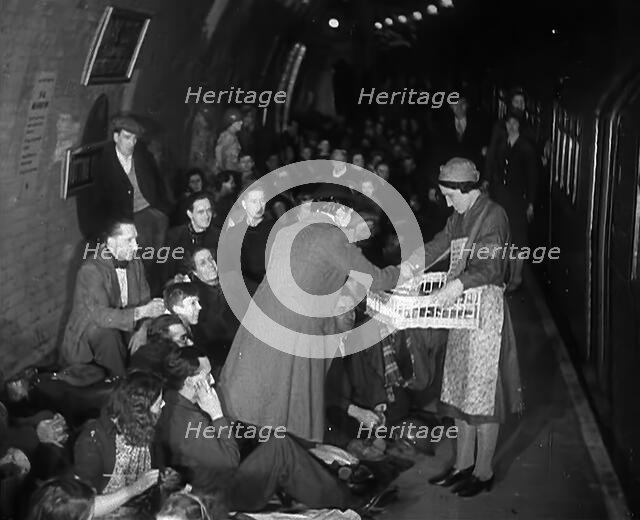 Civilians are Served Refreshments While Sheltering from Bombs in the London Underground, 1940. Creator: British Pathe Ltd.