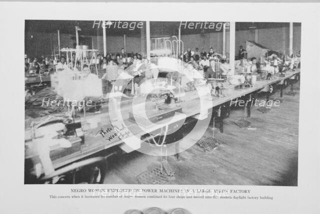 Negro women employed on power machines in a large apron factory, 1922. Creator: Unknown.