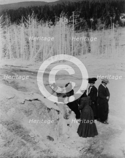 A group of tourists explore land formations in Yellowstone National Park, 1903. Creator: Frances Benjamin Johnston.