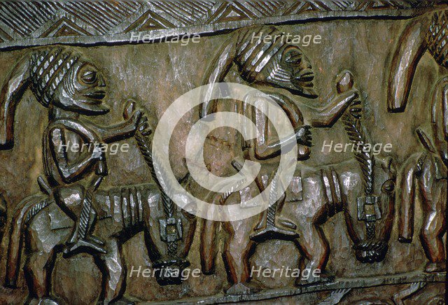 A carved wooden door from Nigeria depicting men on horseback. Artist: Unknown