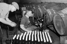 Port wine being bottled from the barrel at the Cutler Street warehouses, London, c1945-c1965.  Artist: SW Rawlings